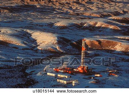 Onshore Oil Drilling Rig in Mountainous Snow Covered Terrain View Large Photo Image Picture - Onshore Oil Drilling Rig in Mountainous Snow Covered Terrain. Fotosearch