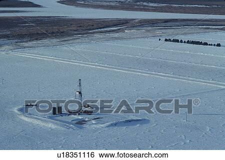 Stock Photograph - Onshore Oil Drilling Rig in Snow Covered Terrain. Fotosearch