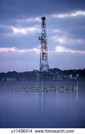 Onshore Oil Drilling Rig Reflection in Water View Large Photo Image Picture - Onshore Oil Drilling Rig Reflection in Water. Fotosearch