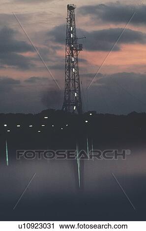 Onshore Oil Drilling Rig Reflection in Water at Twilight View Large Photo Image Stock Image - Onshore Oil Drilling Rig Reflection in Water at Twilight. Fotosearch