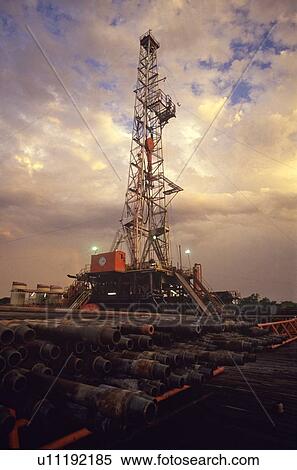 Onshore Oil Drilling Rig with Drill Pipe Stacked in Foreground View Large Photo Image Stock Photography - Onshore Oil Drilling Rig with Drill Pipe Stacked in Foreground. Fotosearch