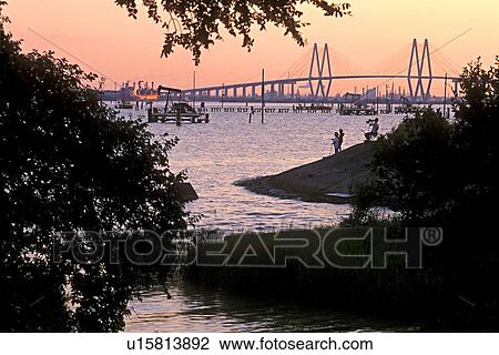 People Fishing on Bank of Channel with Fred Hartman Bridge in Background View Large Photo Image Stock Image - People Fishing on Bank of Channel with Fred Hartman Bridge in Background. Fotosearch