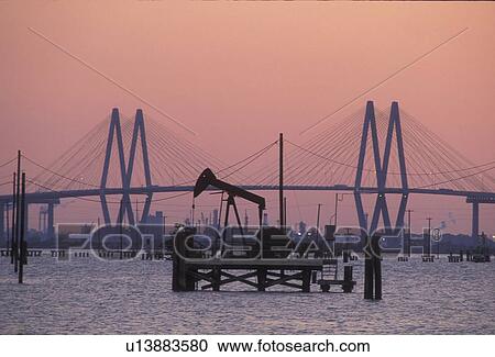 Pump Jack Operating in Houston Ship Channel with Fred Hartman Bridge View Large Photo Image Stock Image - Pump Jack Operating in Houston Ship Channel with Fred Hartman Bridge. Fotosearch
