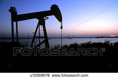 Pump Jack with Houston Ship Channel and Fred Hartman Bridge in Background View Large Photo Image Stock Photo - Pump Jack with Houston Ship Channel and Fred Hartman Bridge in Background. Fotosearch
