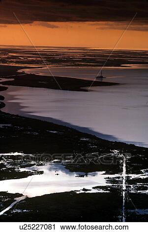 Stock Image - Shallow Water Oil Drilling Barge Operating in Coastal Water. Fotosearch