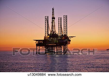 Silhouete of Offshore Oil Drilling Rig at Sunset View Large Photo Image Picture - Silhouete of Offshore Oil Drilling Rig at Sunset. Fotosearch