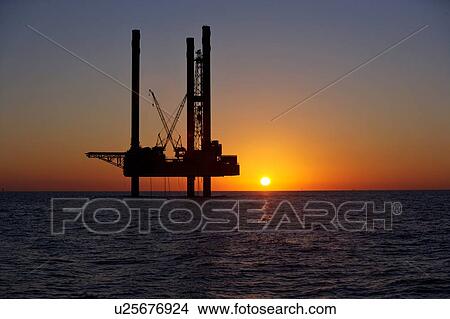 Silhouete of Offshore Oil Drilling Rig at Sunset View Large Photo Image Picture - Silhouete of Offshore Oil Drilling Rig at Sunset. Fotosearch