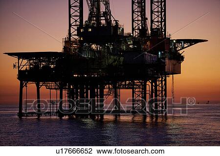 Stock Image - Silhouete of Offshore Oil Drilling Rig at Sunset. Fotosearch