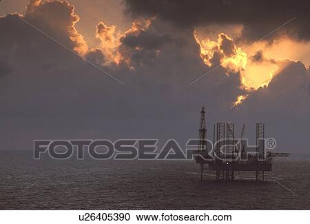 Stock Image - Silhouete of Offshore Oil Drilling Rig at Sunset. Fotosearch