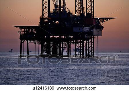 Silhouete of Offshore Oil Drilling Rig at Sunset View Large Photo Image Stock Photo - Silhouete of Offshore Oil Drilling Rig at Sunset. Fotosearch