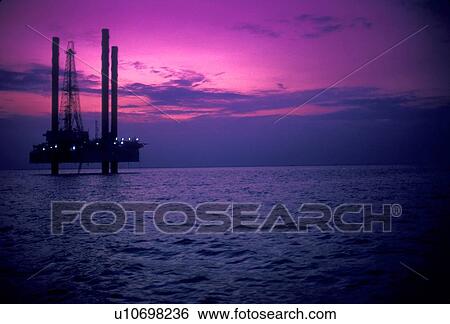 Stock Photograph - Silhouete of Offshore Oil Drilling Rig at Sunset. Fotosearch