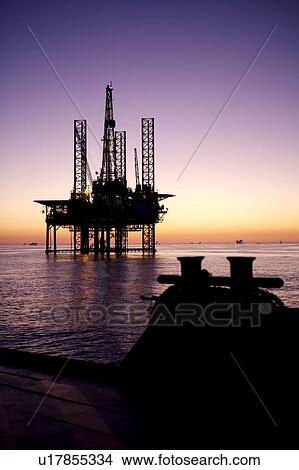 Silhouete View from Supply Boat of Offshore Oil Drilling Rig at Sunset View Large Photo Image Picture - Silhouete View from Supply Boat of Offshore Oil Drilling Rig at Sunset. Fotosearch