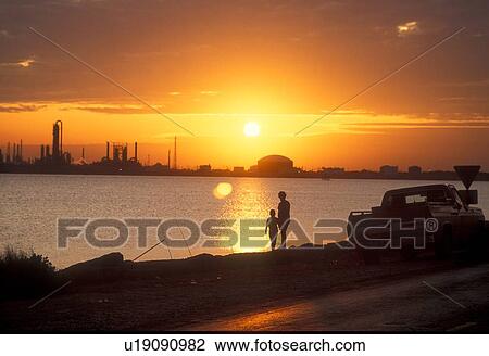 Silhouette of Mother and Child with Oil Refinery in Background at Sunset View Large Photo Image Stock Image - Silhouette of Mother and Child with Oil Refinery in Background at Sunset. Fotosearch