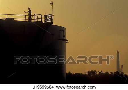 Silhouette of Oil Storage Tank and San Jacinto Monument View Large Photo Image Picture - Silhouette of Oil Storage Tank and San Jacinto Monument. Fotosearch