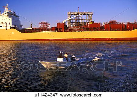 Small Boat and Oil Tanker in Background View Large Photo Image Stock Photo - Small Boat and Oil Tanker in Background. Fotosearch