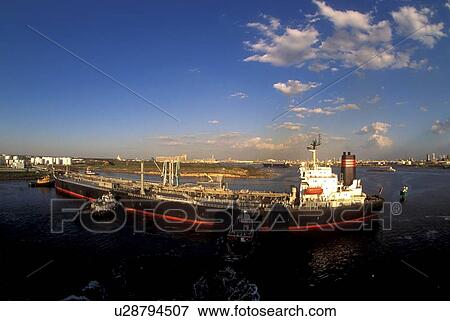 Stock Photo - Tugboats Moving Oil Tanker. Fotosearch