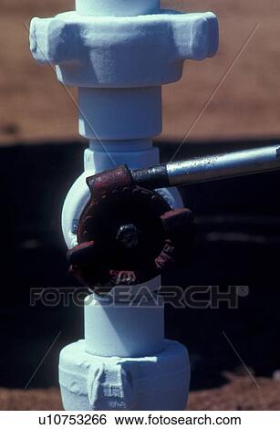 Turning Valve at Wellhead View Large Photo Image Stock Photograph - Turning Valve at Wellhead. Fotosearch