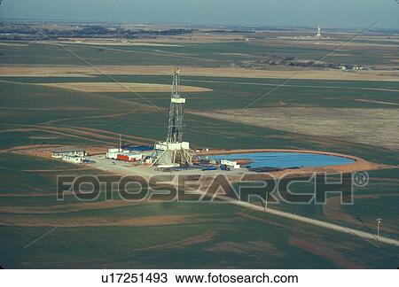 Stock Image - Two Onshore Oil Drilling Rigs in Farmland. Fotosearch