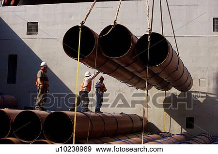 Workers Offloading Pipe from Cargo Ship View Large Photo Image Stock Photo - Workers Offloading Pipe from Cargo Ship. Fotosearch