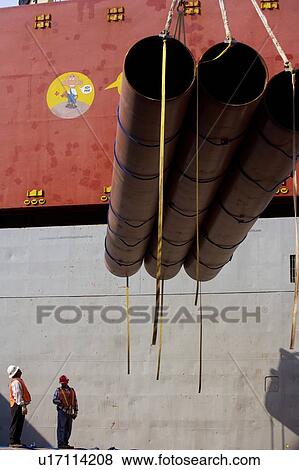 Stock Photo - Workers Offloading Pipe from Cargo Ship. Fotosearch