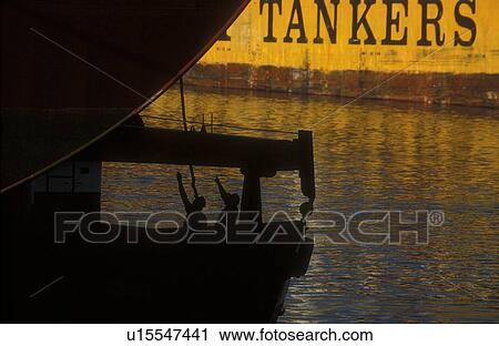 Stock Image - Workers Securing Rope on Oil Tanker. Fotosearch