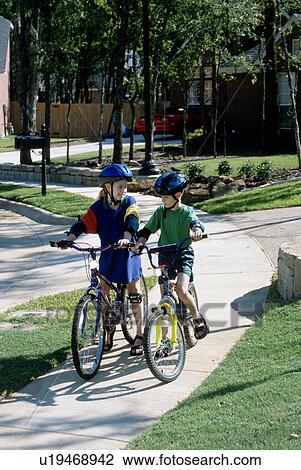 Stock Image - bikes, girl, riding, kids, children, boy. Fotosearch