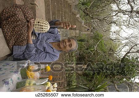 Stock Photo - birds, people, selling, laos, person, woman. Fotosearch