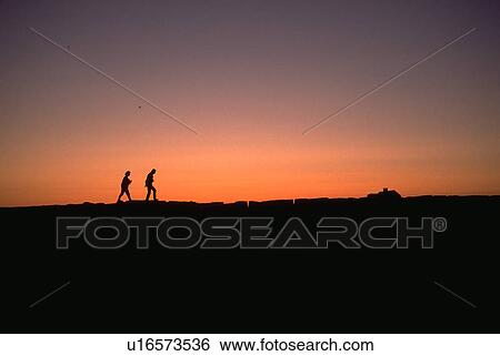 Stock Photograph - coast, people, sunset, walking, nature, beach. Fotosearch