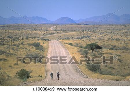 desolate, walking, road, dirt, long, people View Large Photo Image Stock Photo - desolate, walking, road, dirt, long, people. Fotosearch
