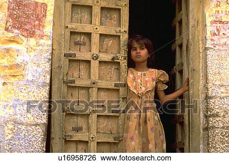 Stock Photograph - door, child, out, looks, kid, girl. Fotosearch