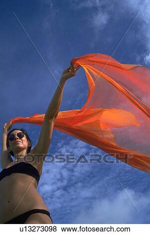 Stock Photo - holds, woman, bikini, black, female, young. Fotosearch