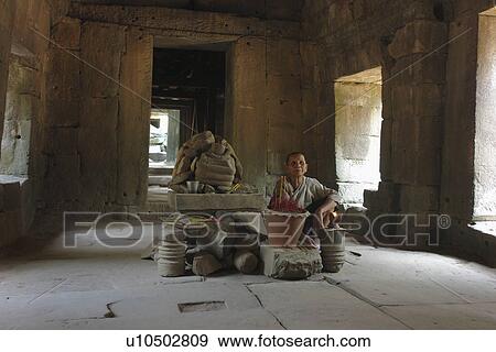Stock Photo - people, shrine, cambodia, person, tree. Fotosearch