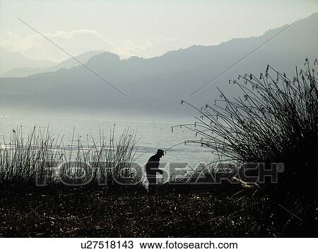 Stock Image - person, lake, standing, guatemala, people. Fotosearch