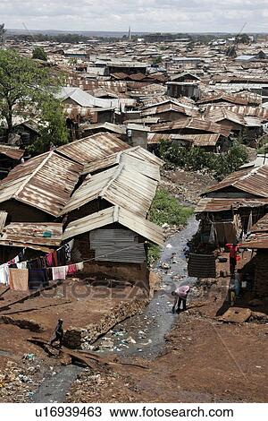 Stock Image - roofs, person, tin, rusted, kenya, people. Fotosearch