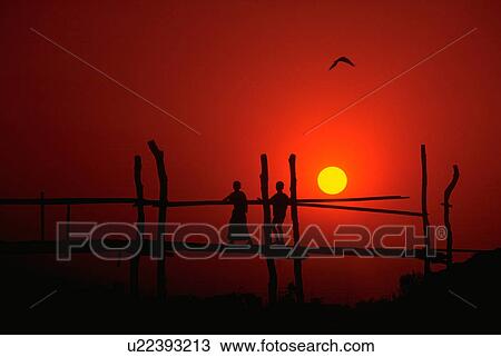 Stock Image - silhouetted, young, bridge, cross, boys, two. Fotosearch