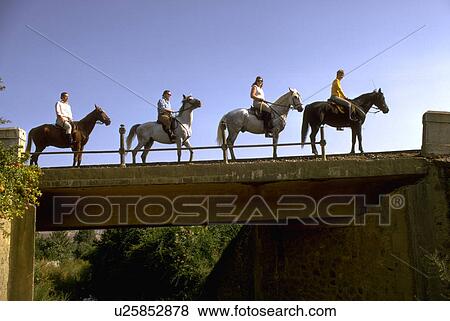 Stock Photo - spain, ride, alora, bridge, horseback, people. Fotosearch