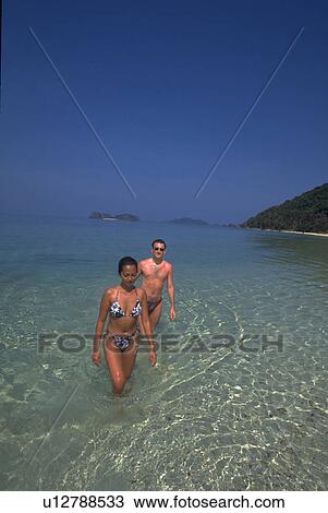 Stock Image - beach, lovers, couple, love, woman. Fotosearch