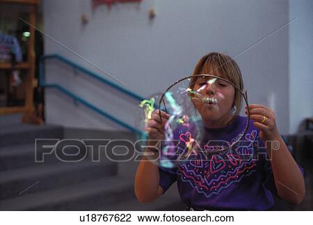 Stock Image - blowing, released, girl, kid, child, model. Fotosearch