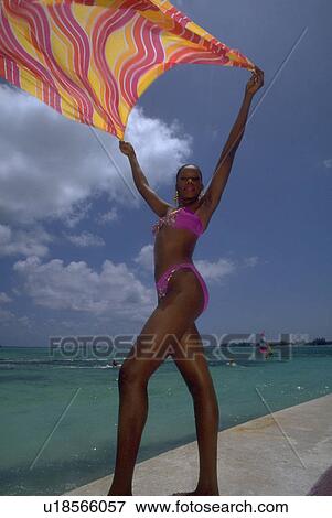 Stock Photo - brightly, black, holds, female, woman, young. Fotosearch