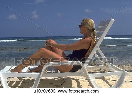 chaise, blonde, sits, female, woman, young View Large Photo Image Stock Image - chaise, blonde, sits, female, woman, young. Fotosearch