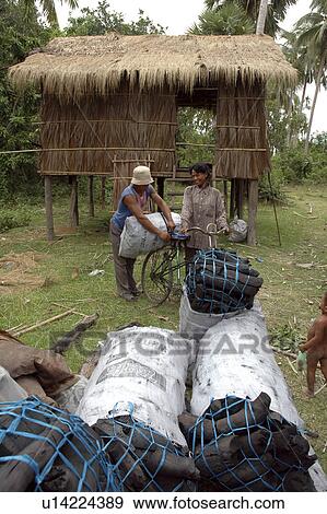 Stock Photo - charcoal, people, cambodia, person, house, woman. Fotosearch