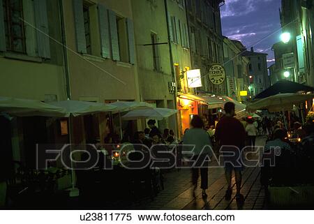 Stock Photography - commercial, nyons, walking, tourists, dusk, people. Fotosearch
