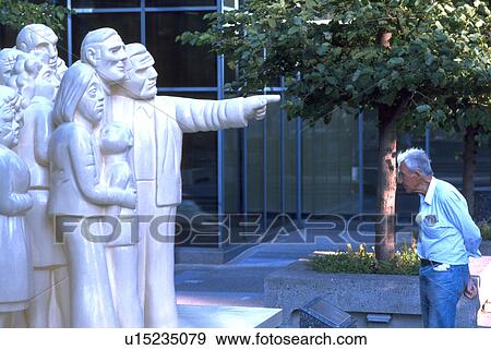 Stock Photo - hand, statue, crowd, illuminated, people. Fotosearch