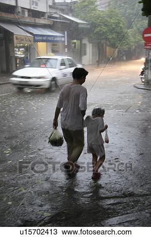 Stock Image - hanoi, person, day, rainy, vietnam, people. Fotosearch