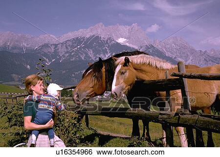 Stock Photograph - horse, female, looks, kid, child, woman. Fotosearch