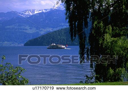 Stock Photo - lake, topped, ferry, local, mountains, snow. Fotosearch
