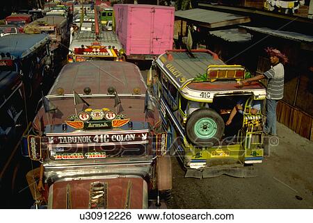 Stock Photograph - male, jeepney, back, hangs, filipino. Fotosearch