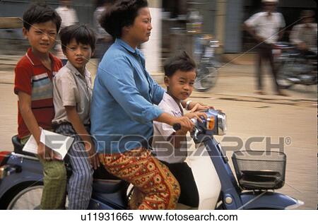Stock Photography - phnom, people, motorcycle, cambodia, person, family. Fotosearch