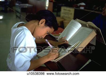 Stock Photo - read, student, girl, library, studies, college. Fotosearch