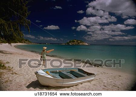 Picture - sand, woman, white, walks, female, young. Fotosearch